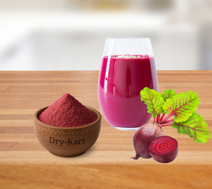 A bowl of beetroot powder beside a beetroot smoothie and fresh beetroot.